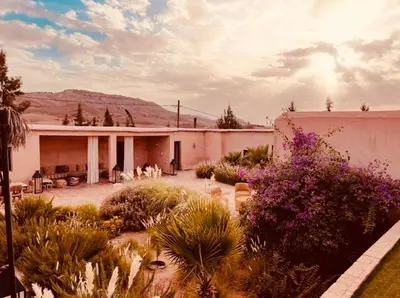 a house with a yard with plants and flowers at Hacienda Joud Marrakech-Safi in Ben Bouih