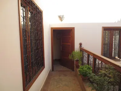 a hallway of a house with a door and some plants at Dar Essoaoude - Fes Nejjarine in Fès