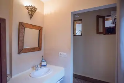 a bathroom with a sink and a mirror at Dar Essoaoude - Fes Nejjarine in Fès