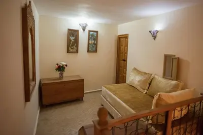 a small living room with a couch and a table at Dar Essoaoude - Fes Nejjarine in Fès