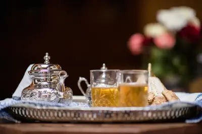 a tray with two glasses of tea on a table at Dar Essoaoude - Fes Nejjarine in Fès