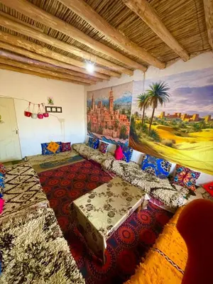 a room with beds and a painting on the wall at Olecactus in Gourrama