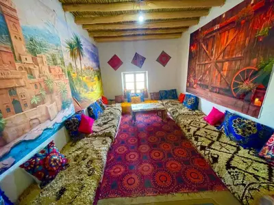 a living room with a couch and a colorful carpet at Olecactus in Gourrama
