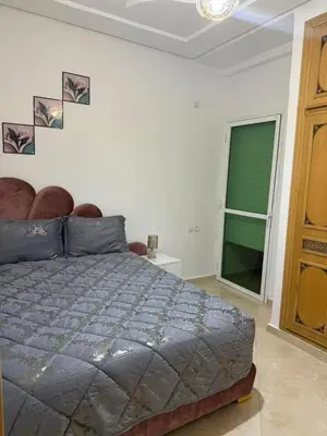 a bedroom with a bed and a window in it at Appartement de luxe in Fès