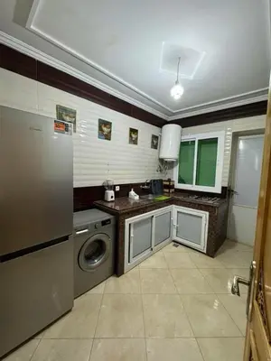 a kitchen with a washing machine and a washer at Appartement de luxe in Fès
