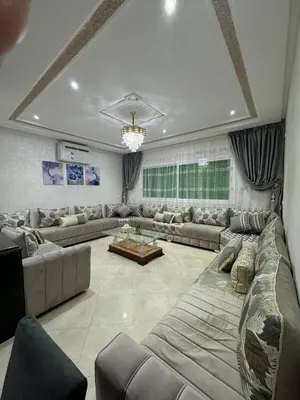 a large living room with couches and a table at Appartement de luxe in Fès