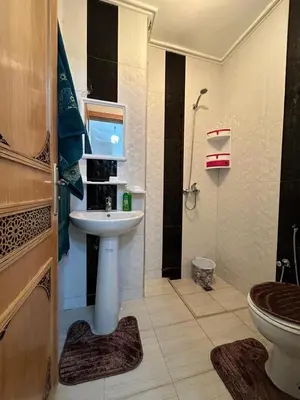a bathroom with a sink and a toilet at Appartement de luxe in Fès
