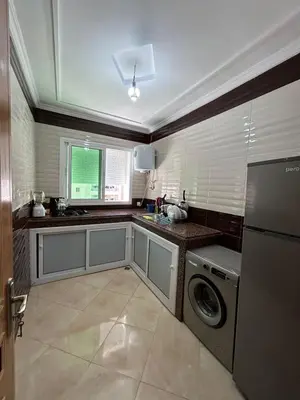 a kitchen with a washer and dryer in it at Appartement de luxe in Fès