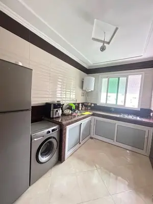 a kitchen with a dishwasher and a washer in it at Appartement de luxe in Fès