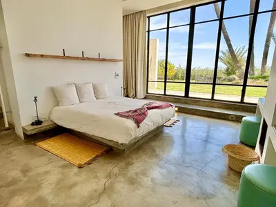 a bedroom with a bed and a large window at Palais Akbal in Marrakech