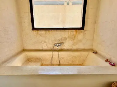 a bath tub with a window in a bathroom at Palais Akbal in Marrakech