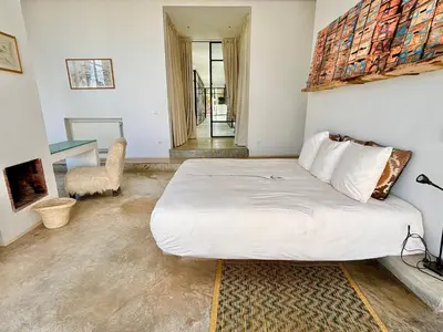 a bedroom with a large white bed and a table at Palais Akbal in Marrakech
