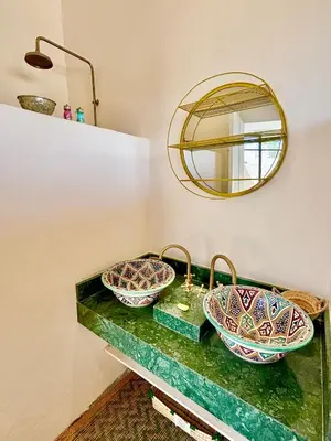 a bathroom with two sinks and a mirror at Palais Akbal in Marrakech
