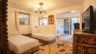 a living room with two beds and a tv at Studio Azur in Bine el Ouidane