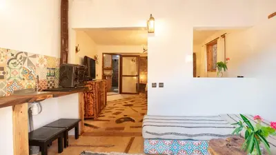 a living room with a couch and a table at Studio Azur in Bine el Ouidane
