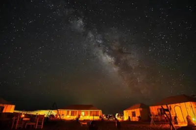 a starry night with the milky way in the sky at Luxury Merzouga Desert Camp in Merzouga