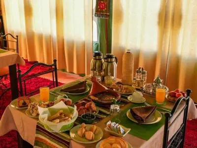 a table with plates of food on it at Awesome Luxury Camp in Merzouga