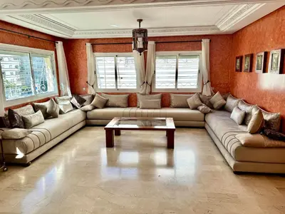 a living room with a couch and a coffee table at Appartement centre-ville avec Wifi fibre optique in Fès