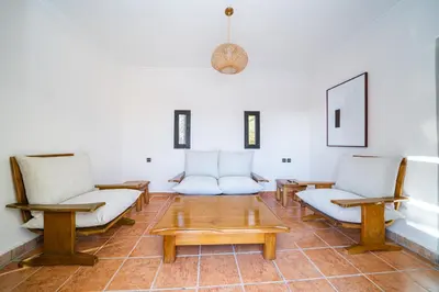 a living room with two chairs and a coffee table at Palais Aureola Luxury Padel and Home Cinema in NʼChaba
