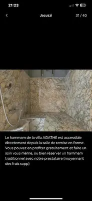 a screenshot of a bathroom with a sign on the wall at Villa avec piscine chauffée in Marrakech