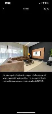a picture of a room with a bed and a tv at Villa avec piscine chauffée in Marrakech