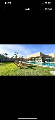 a picture of a building with a swimming pool at Villa avec piscine chauffée in Marrakech