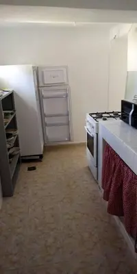 a kitchen with a stove and a refrigerator at Chalet Authentique Au Centre-Ville in Ifrane