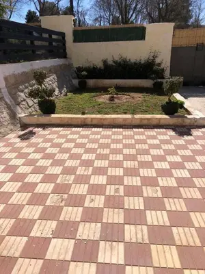 a brick patio with a bench in a yard at Chalet Authentique Au Centre-Ville in Ifrane