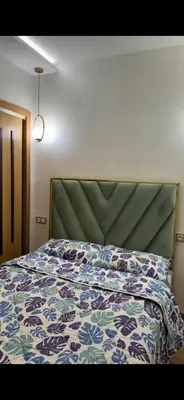 a bedroom with a bed with a floral comforter at حدائق افران in Ifrane