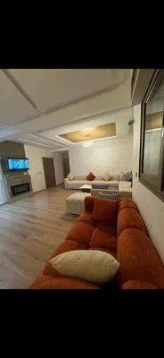 a large living room with a couch and two beds at حدائق افران in Ifrane