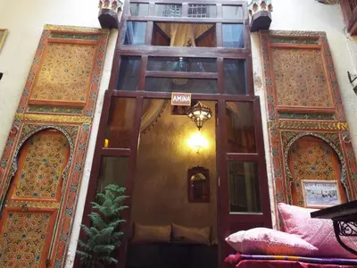 an entrance to a building with wooden doors at Dar Fès Huda in Fès