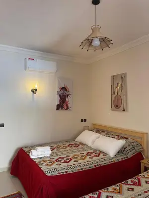 a bedroom with a bed and a ceiling at Dyafat Abla in Ouarzazate