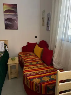 a living room with a couch and a bed at Dyafat Abla in Ouarzazate