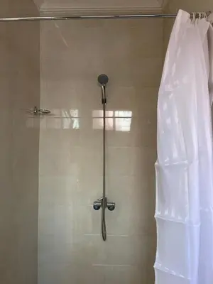 a shower in a bathroom with a shower curtain at Dyafat Abla in Ouarzazate