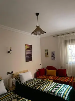 a living room with two beds and a couch at Dyafat Abla in Ouarzazate