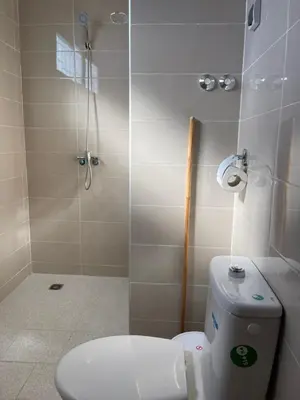 a small bathroom with a toilet and a shower at Dyafat Abla in Ouarzazate