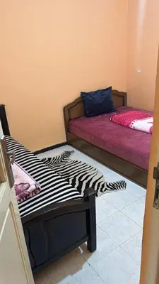two beds in a room with a zebra print at Appartement Sérénité in Khemisset