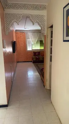 a hallway of a room with a door and a tile floor at Appartement Sérénité in Khemisset