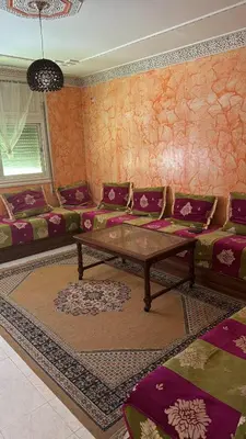 a living room with a couch and a table at Appartement Sérénité in Khemisset