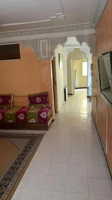 a living room with a couch and a tile floor at Appartement Sérénité in Khemisset