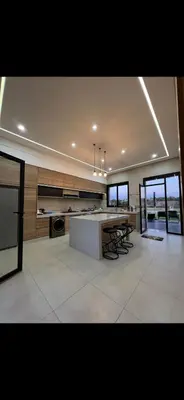 a large kitchen with a counter and some windows at Perfekt villa Marrakech in Marrakech