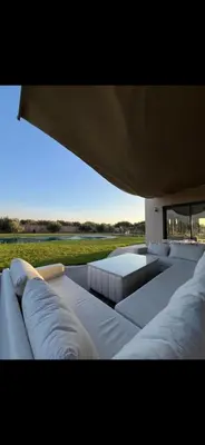 a living room with white furniture and a large window at Perfekt villa Marrakech in Marrakech