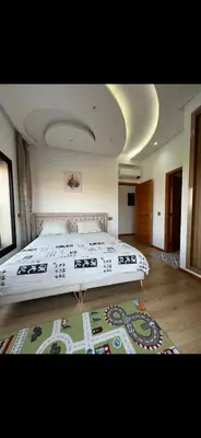 a bedroom with a large bed and a rug at Perfekt villa Marrakech in Marrakech