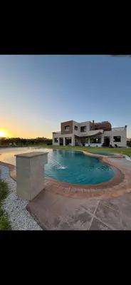 a large swimming pool in front of a building at Perfekt villa Marrakech in Marrakech