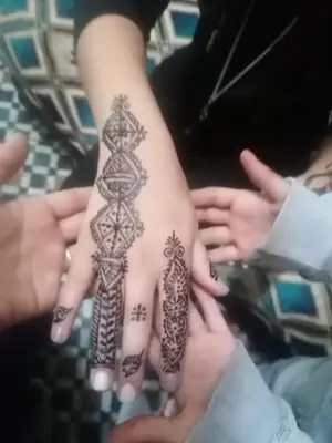 a woman with mehndi on her hand at Dar lmallouki 1 in Fès