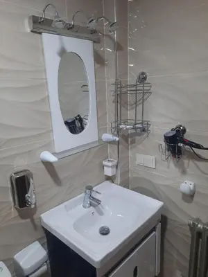 a bathroom with a sink and a mirror at appartement amira ifrane in Ifrane