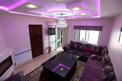 a living room with a couch and a table at appartement amira ifrane in Ifrane