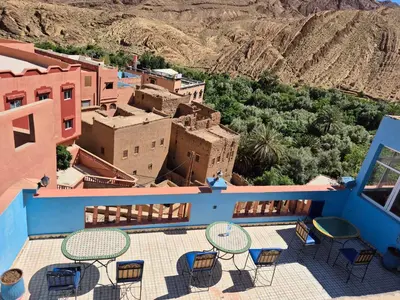 a patio with chairs and tables on top of a building at Riad La Fleur in Aït Baha