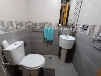 a bathroom with a toilet and a sink at Belle vacances dans mon App in Meknès