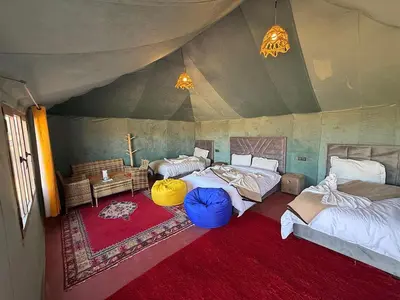a room with three beds in a tent at Serenity Sky Luxury Camp in Merzouga